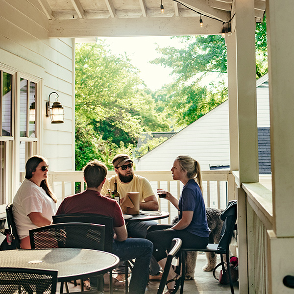 Diners enjoying pizza on the patio