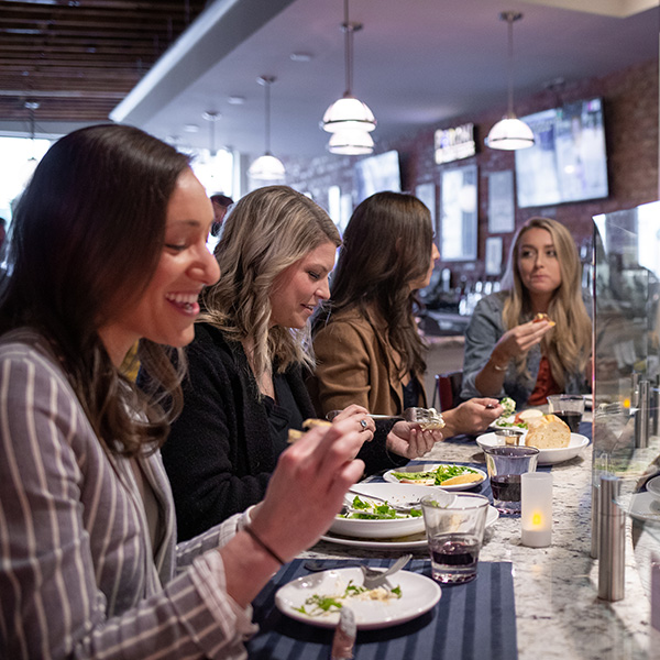 Diners enjoy Neapolitan pizza